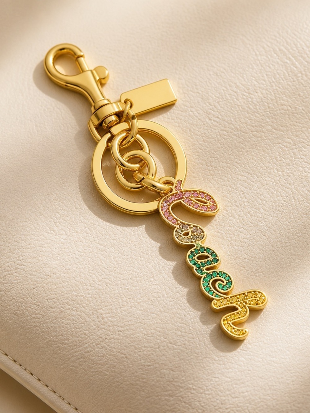 Coach Gold-Tone 'Queen' Script Key Charm with Pink, Green and Yellow Crystals